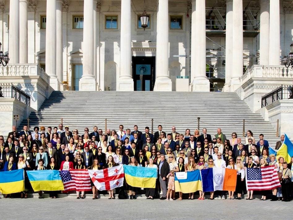 Group with flags on building steps.